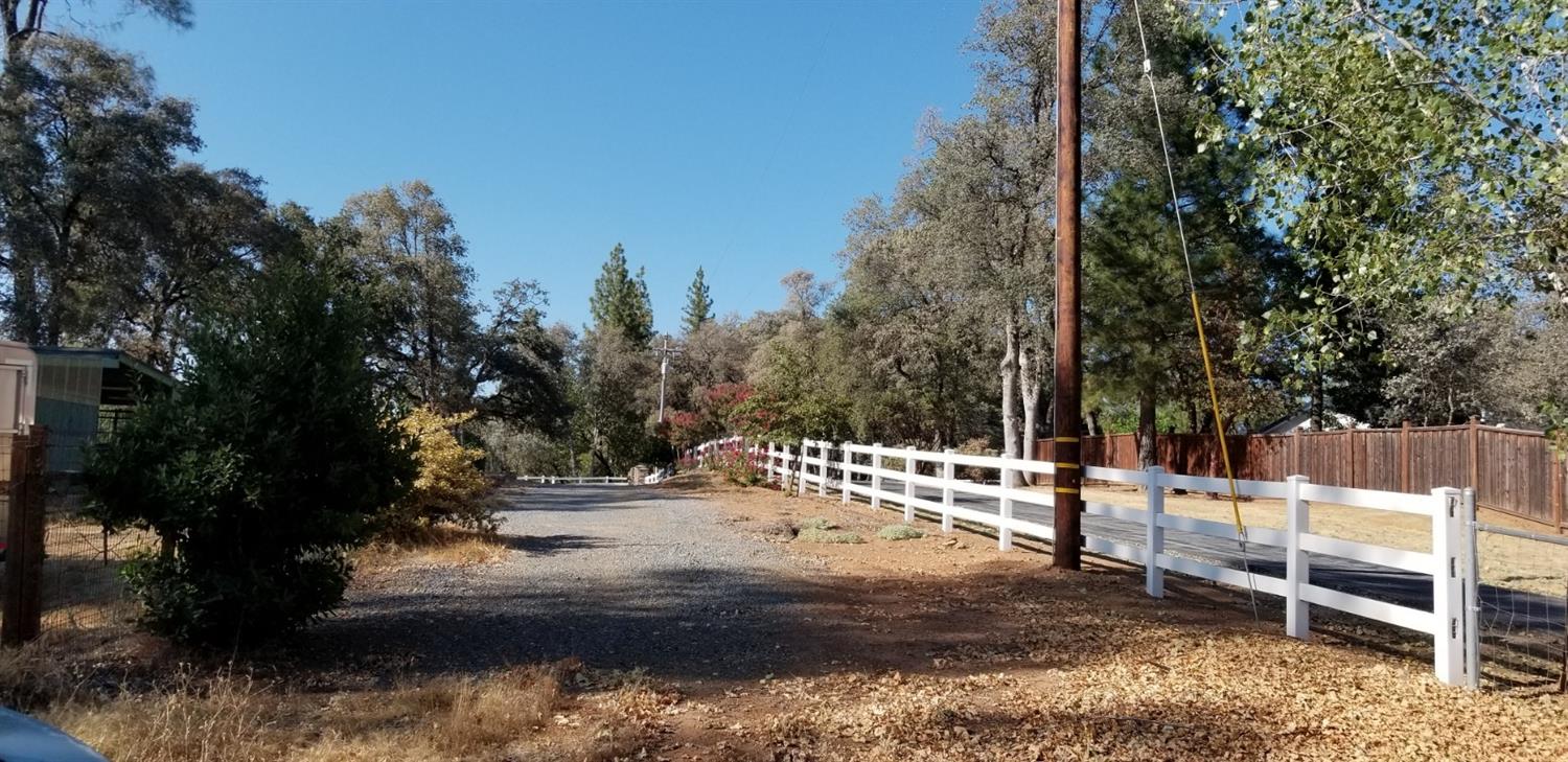 Standing on property looking out easement road towards the Rim Rock columned entrance.  Neighbors Fenced horses and stalls to the left at this view.  Utilities available at the neighbor entrance and down the easement road towards this property for sa