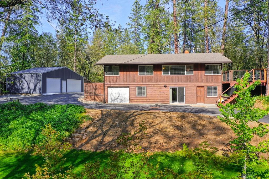 This one has it all! Close to town yet the feeling of seclusion & privacy!  The property is 2.4 acres with manicured lawns, a seasonal pond, a Huge 40X22 Metal 3 Car Garage/Workshop plus a 1 Car Attached Garage, Storage Shed, Well water, & More.  The home is 2260 sq. ft. with 4 bedrooms and 3 full bathrooms. Most of the main living is upstairs leading out to the large deck, great for entertaining and gatherings with a fenced-in yard perfect for your animals. Downstairs has a great potential to be utilized as an In-laws' Quarters, Separate Rental Unit, VRBO, etc with its own 1 car attached garage, a bedroom, full bathroom, living room, access to Laundry and its own separate entrance! All you need is to add a little kitchenette, & it's ready to go as its own separate unit! Large laundry/utility room w/ an extra storage room perfect for your wine collection. Outside the manicured yard below is complete w/ a Kids Clubhouse / She Shed, tetherball, & a fire pit. Check out the 3D floorplan.