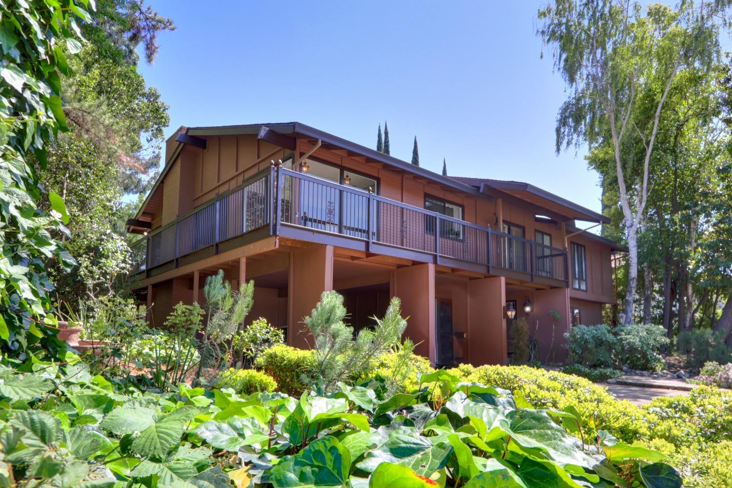 Wow! Check out this amazing custom Wilhaggin home backing up to the American River Parkway! Welcome to this one-of-a-kind treetop gem where you do most of your living upstairs! So much natural light! Vaulted ceilings in your huge family room w/dining area, large kitchen, formal office, formal living room & spacious primary bedroom w/en suite bath. Step outside of any room onto your wrap-around balcony w/views of the AR Pkwy or your huge swimming pool/spa below. Excellent public schools K-12 nearby along w/dozens of restaurants. Absolute entertainer's dream!