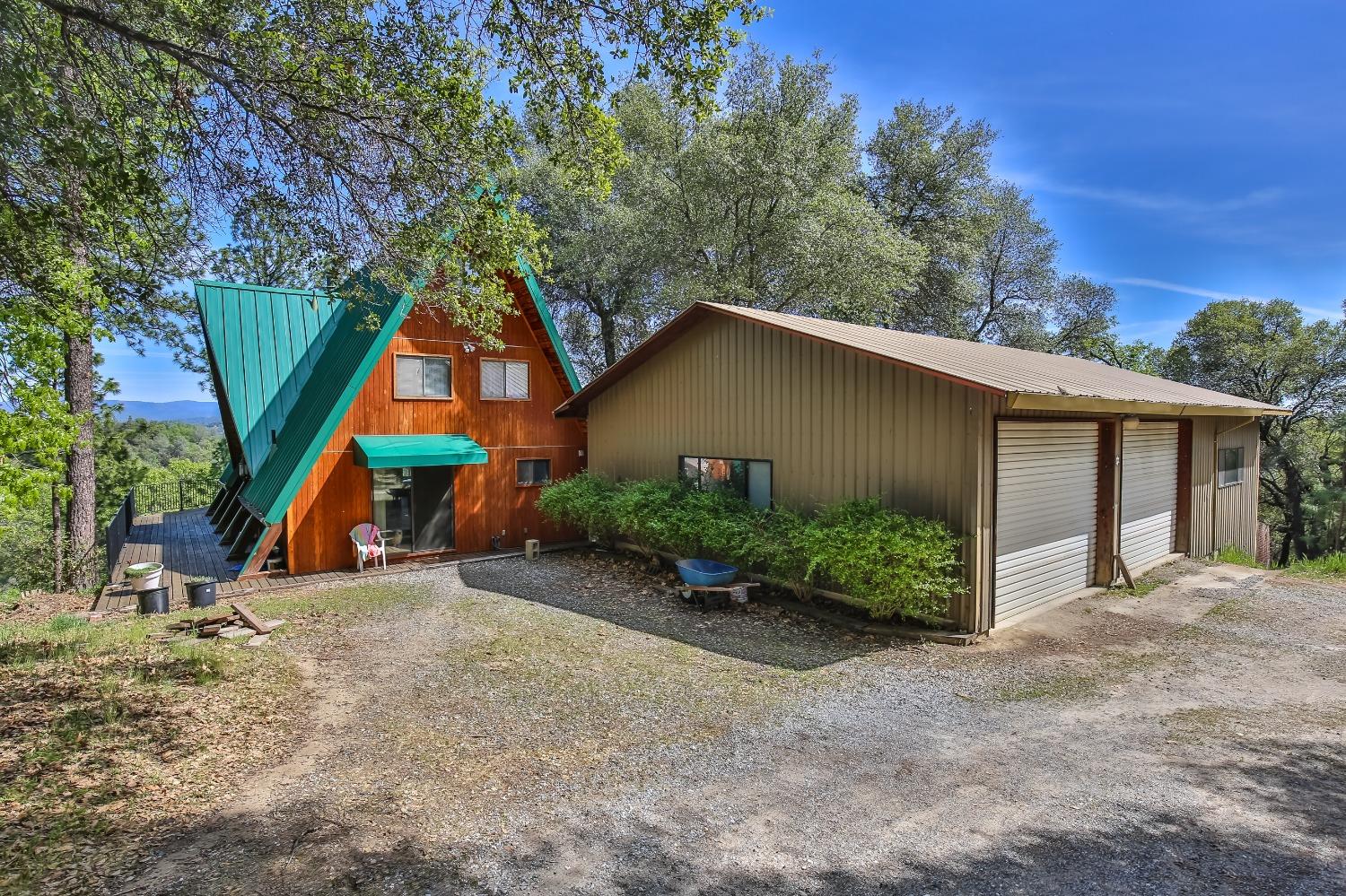 You can build a home anywhere, but you can't build a VIEW! Come enjoy the Majestic forever views of The Sierras & Pyramid Peak in this tranquil private setting on 5 acres. This multi level home has a great floor plan with 1,860 sq. ft. with 4 bedrooms and 2 1/2 baths, a good sized kitchen and large family room with a vaulted cathedral ceiling lined with pecky cedar wood & a cozy wood burning stove & large view windows. The downstairs features a large 600 sq. ft bonus room. The outdoors entertainers resort will astound you with over 1000 sq. ft. of decking, sparkling swimming pool, tiki bar and more. The oversized Garage is 900 sq. ft. plus it has a 600 sq. ft. workshop too! near year round pond. There is also a pole barn for your extra toys and a chicken coop too. the home has 100 year metal roof. Only 15 minutes to hwy 50 and 1 hour to Lake Tahoe & close to the wine Country. The list goes on and on. You will never even want to leave home! A MUST SEE!