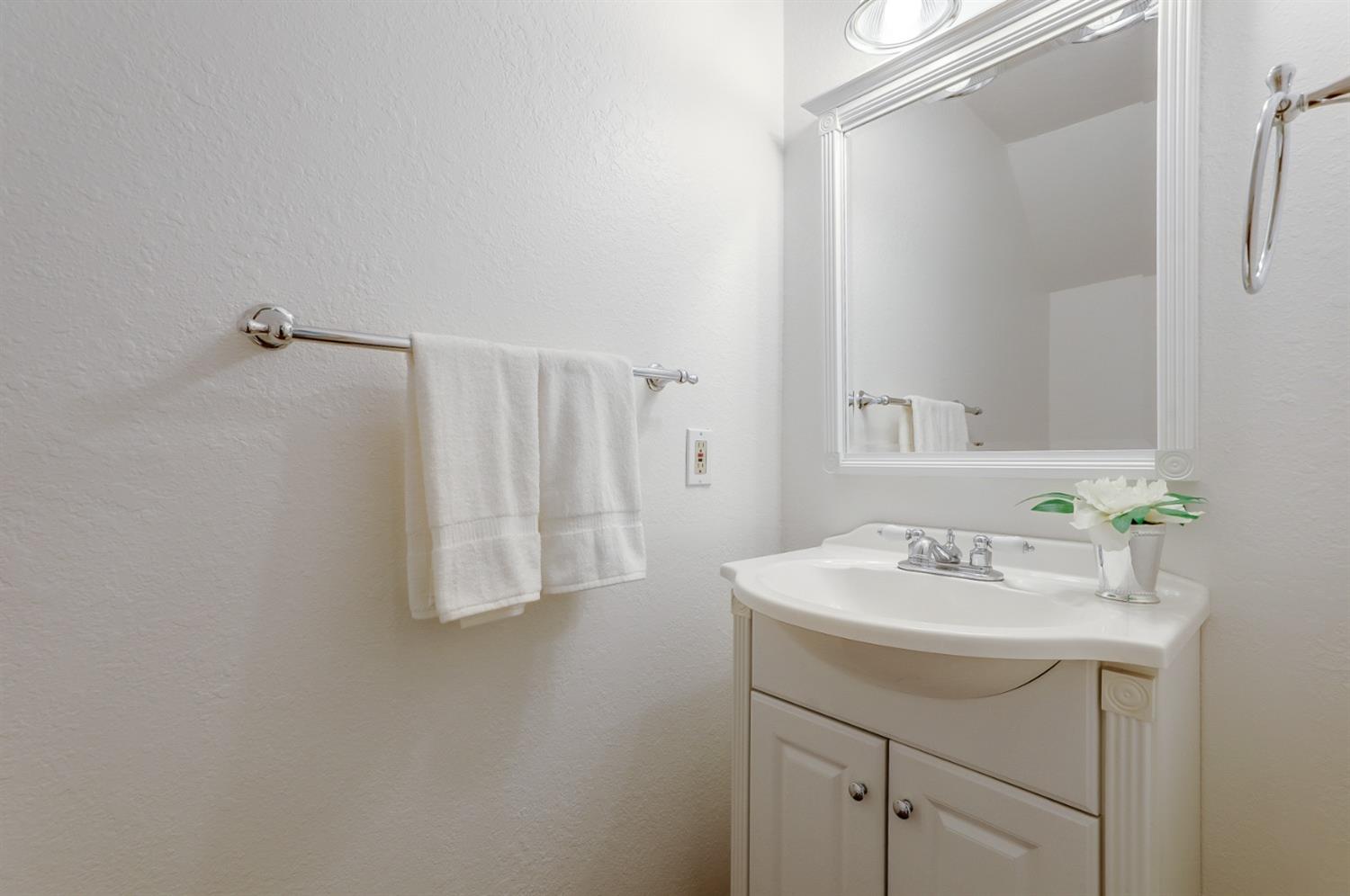 Photo #6 The hall half bath is light and bright!  Conveniently located between the main living area and the kitchen.