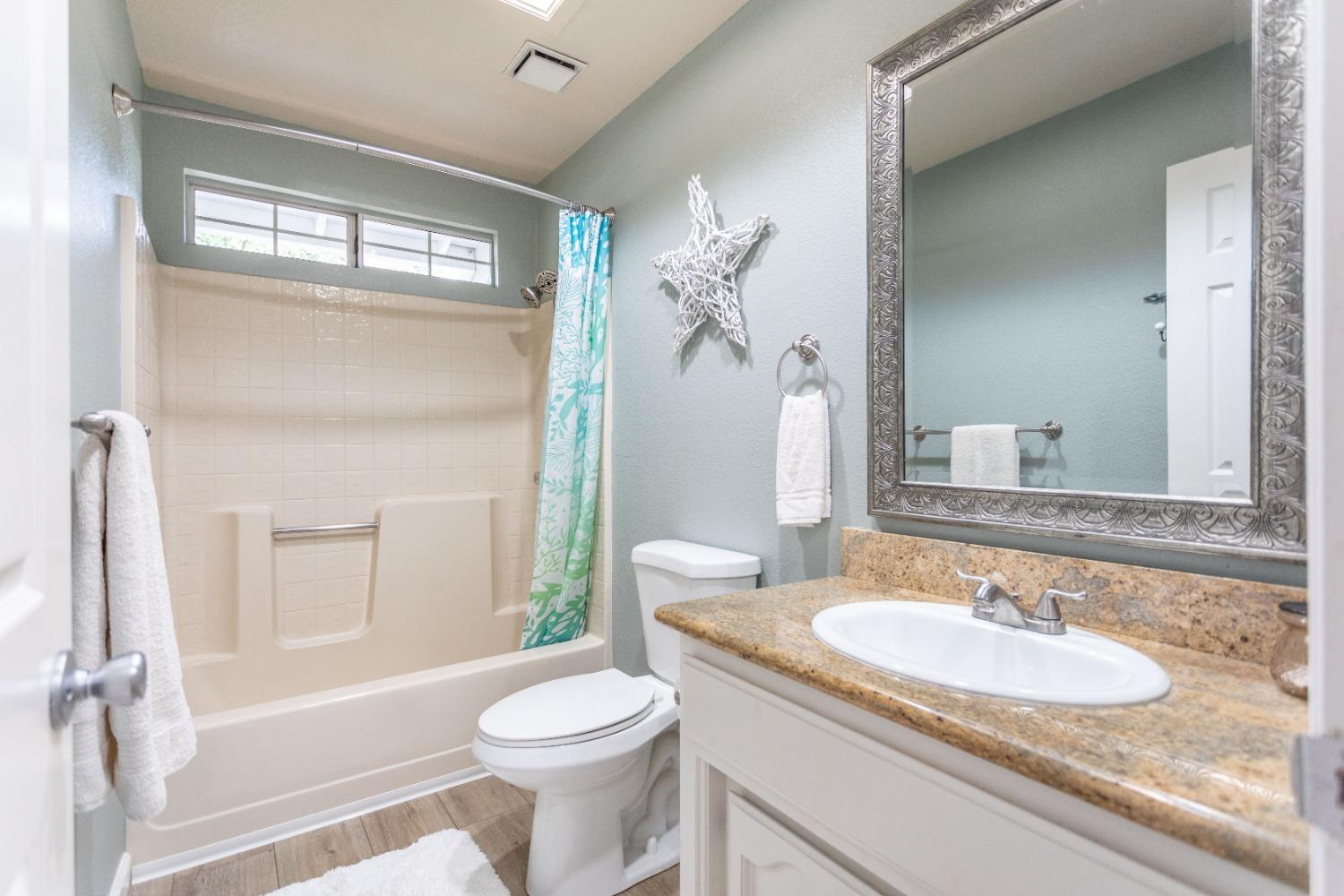 Hall bathroom with shower over tub