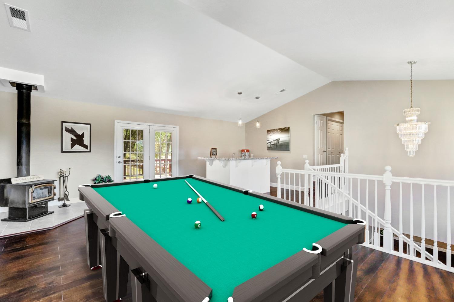 Family room with wet bar has so many possibilities! Pool table digitally enhanced.
