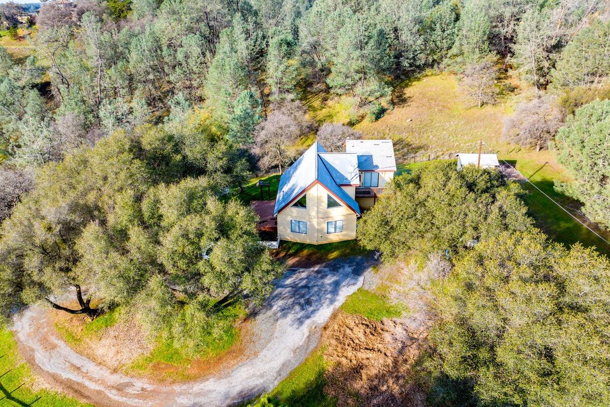 Private foothill home overlooking an oak-studded local valley near the end of a country road. With r