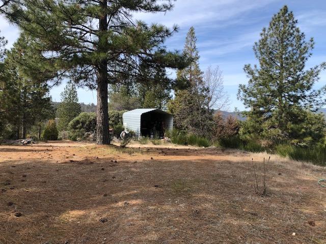 This property encompasses a very level and cleared hilltop, with 360 views, and the most of the hill surrounding.  Very private and secluded.  There is an ag well on property, that runs off generator. Well is approximately 2.5 Gallons a minute with a 2500 water storage tank. There are two sheds on top. One Large enough to become a tiny home.  Solar power Panels are owned, and on roof of the shed. One large garden area with 75 foot trenches, 2 feet deep, and drainage and water to area. Property is almost fully fenced, two small sections missing. no drive-bys caretaker present.