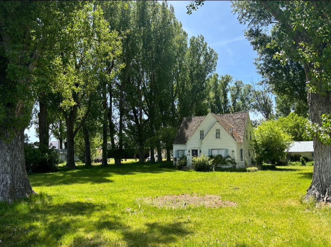 Classic Farmhouse, w/huge insulated shop. Sitting in a grove of mature trees, in the farmlands of Tulelake, this fixer could be brought back to it's former glory! Two 4 acre fenced pastures, with Class A water rights, 2 wheel lines, main line and 3 inch solid set included. Coved ceilings, built-ins throughout, and views of farmland as far as the eye can see, are some great features of this grand property. Enclosed metal, insulated shop has large 3 sided attached portion which could provide great shelter for livestock with a little creative fencing. Home has 1 bed down and 3 beds up, 1 bath down and 1 bath up. Separate utility/laundry room off kitchen, w/ sink and wall of pantry space. All windows dual paned. Bedrooms upstairs have built-in dressers. Bedroom downstairs has closet across hall. All rooms are spacious with good closet space. Three additional dwelling units, are non functional as dwelling units, only used as storage by seller. One was a 3 unit apartment building, but may not be salvageable, without extensive work, per seller. Two other units were single family homes, but also need extensive work, if salvageable, per seller. Farmhouse is habitable. Needs roof, but no water damage known/visible at this time, per seller. Driveway is large semi-circle with 2 entrances.