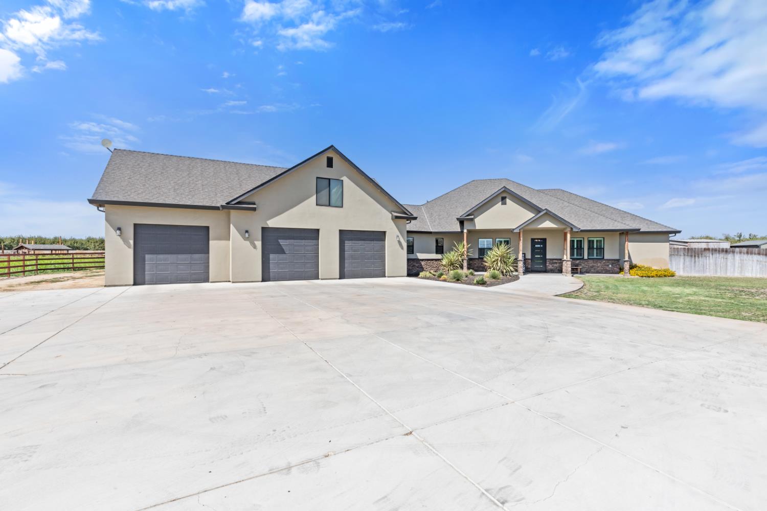 Hilmar Ranchette. This custom-built 2022 home sits on 5.86 acres of irrigated farmland just east of town. The 3,301-square-foot home features 4 bedrooms, 3.5 baths, an open great-room layout, and designer touches throughout.    The kitchen is built to cook and host: KitchenAid stainless steel appliances, a built-in refrigerator, a large island, leathered granite, custom cabinetry, and a walk-in pantry. The primary suite is tucked away with a walk-in closet, rainfall shower, and soaking tub. The laundry room includes a full granite folding counter, upper and lower cabinetry, and a utility sink. The dedicated office is an ideal work-from-home space, guest room, or fifth bedroom. The three-car garage offers an abundance of space for vehicles and storage. An unfinished 900-square-foot attic space is ready for a game room or private retreat you want it.    Owned solar, well water, and TID irrigation. This is a rare newer home with usable land. Come walk it.